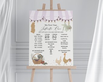 May include: A printable chart for a baby's first year milestones. The chart is decorated with a purple and white striped background, a basket of vegetables, and a rooster and hen. The chart includes the baby's name, birth date, weight, height, firsts, favorite toys, favorite book, and favorite song. The text on the chart reads: "My First Year, Jelfiette Rose, Oct 1st 2019, 9:54 AM, 7LB 9OZ 18IN, Firsts, I Stand, I Weigh, I Can Say, I Love To...", and more.
