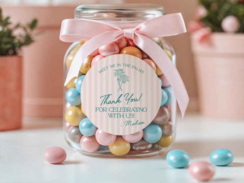 May include: A glass jar filled with colorful candy, tied with a pink ribbon and a thank you tag that reads "Meet me in the palms. Thank you! For celebrating with us! - Madison".