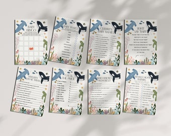 May include: A set of ten printable baby shower game cards featuring a blue and white whale and hammerhead shark design. The games include Baby Bingo, Baby Traits, Celebrity Baby Names, Don't Say Baby, Nursery Rhyme Trivia, Guess the Price, Who Knows Mum Best?, and Would Mum Rather.