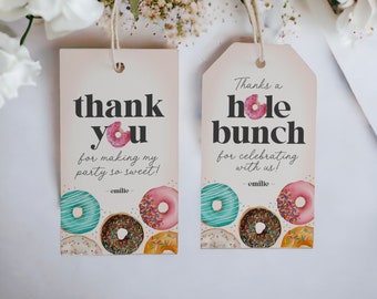 May include: Two gift tags with a light pink background and donut illustrations. One tag reads "thank you" and the other says "Thanks a hole bunch". Both tags have the name "emilie" at the bottom. The tags are tied with twine.