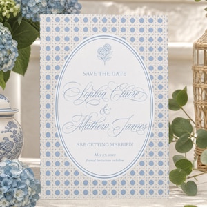 May include: A rectangular Save the Date card featuring a light blue and white cane webbing pattern. A central white oval contains a blue floral icon, the text "SAVE THE DATE", "Sophia Claire & Mathew James", "ARE GETTING MARRIED!", "May 27, 20xx", and "Formal Invitations to follow".