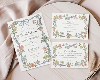 May include: Bridal shower invitations and cards with floral borders. The main invitation features a blue ribbon and text, including the bride's name and event details. Additional cards include registry and recipe information.