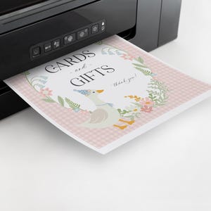 May include: A white printer with a pink and white card with the text "Cards and Gifts - thank you!" printed on it. The card has a floral design with a goose wearing a party hat.