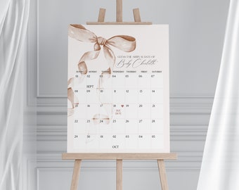 May include: A printable baby shower game featuring a brown ribbon bow design. Guests can guess the arrival date of Baby Charlith by marking the calendar with the date they think the baby will be born. The due date is marked with a pink heart.