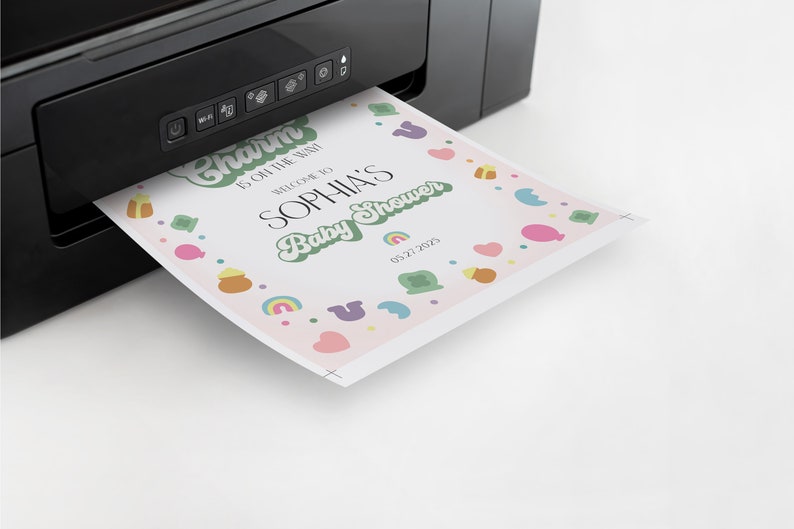 May include: A pink baby shower invitation with green, yellow, and blue accents. The invitation says "Charm is oh the rush! Welcome to Sophia's Baby Shower 03.27.2025".