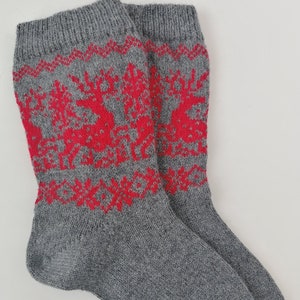Knitted wool socks, red reindeer pattern, unisex wool socks for wintertime, natural and warm, grey model