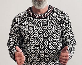 May include: A long-sleeve crew neck sweater featuring a repeating black and white geometric snowflake pattern. The collar and hem are detailed with a thin red and black checkered border. The knit garment has a fitted silhouette and ribbed cuffs.