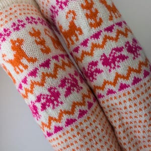 Lovely knitted wool leg warmers with nice dogs and birds pattern, made of fine sheep wool, warm and cozy accessories in a chilly days