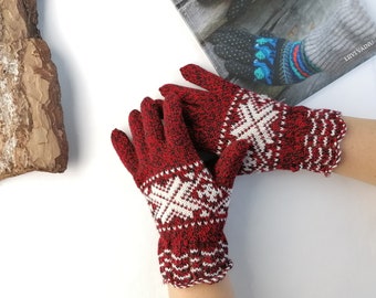 May include: Red and white knitted gloves with a snowflake pattern.