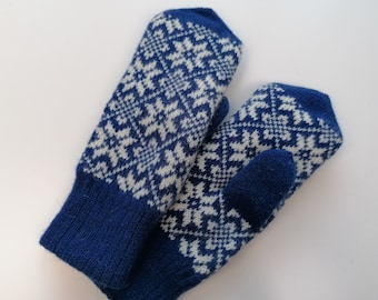May include: A pair of blue and white knitted mittens with a traditional snowflake pattern.