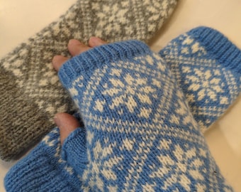 May include: A pair of blue and white knitted fingerless gloves with a geometric pattern, and a gray and white knitted sleeve with a similar pattern. The gloves and sleeve are made of a soft, textured yarn.