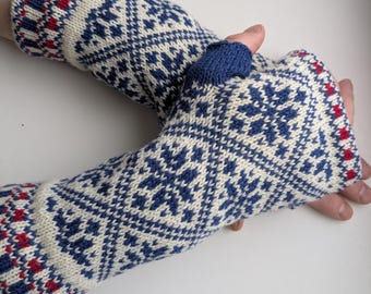 May include: A pair of white, blue, and red knitted fingerless gloves with a snowflake pattern.