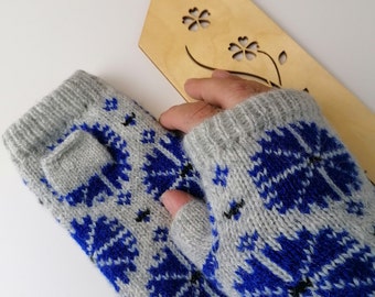 May include: A pair of gray fingerless gloves with a blue and white snowflake pattern.
