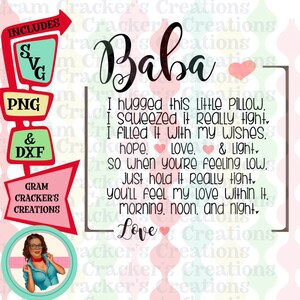May include: A pink and red sign with the text "Baba" and a message about a pillow that holds love and light. The sign includes a retro-style illustration of a woman with glasses and a red heart.