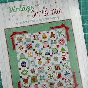 May include: Vintage Christmas quilt pattern book by Lori Holt of Bee in My Bonnet Company. The cover features a colorful quilt design with a variety of Christmas-themed blocks.