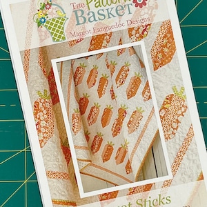 Puede incluir: Un patrón de acolchado para una colcha con un diseño de zanahoria. El patrón se llama "Carrot Sticks" y es de The Pattern Basket de Margot Languedoc Designs. El patrón está disponible en www.thepatternbasket.com.