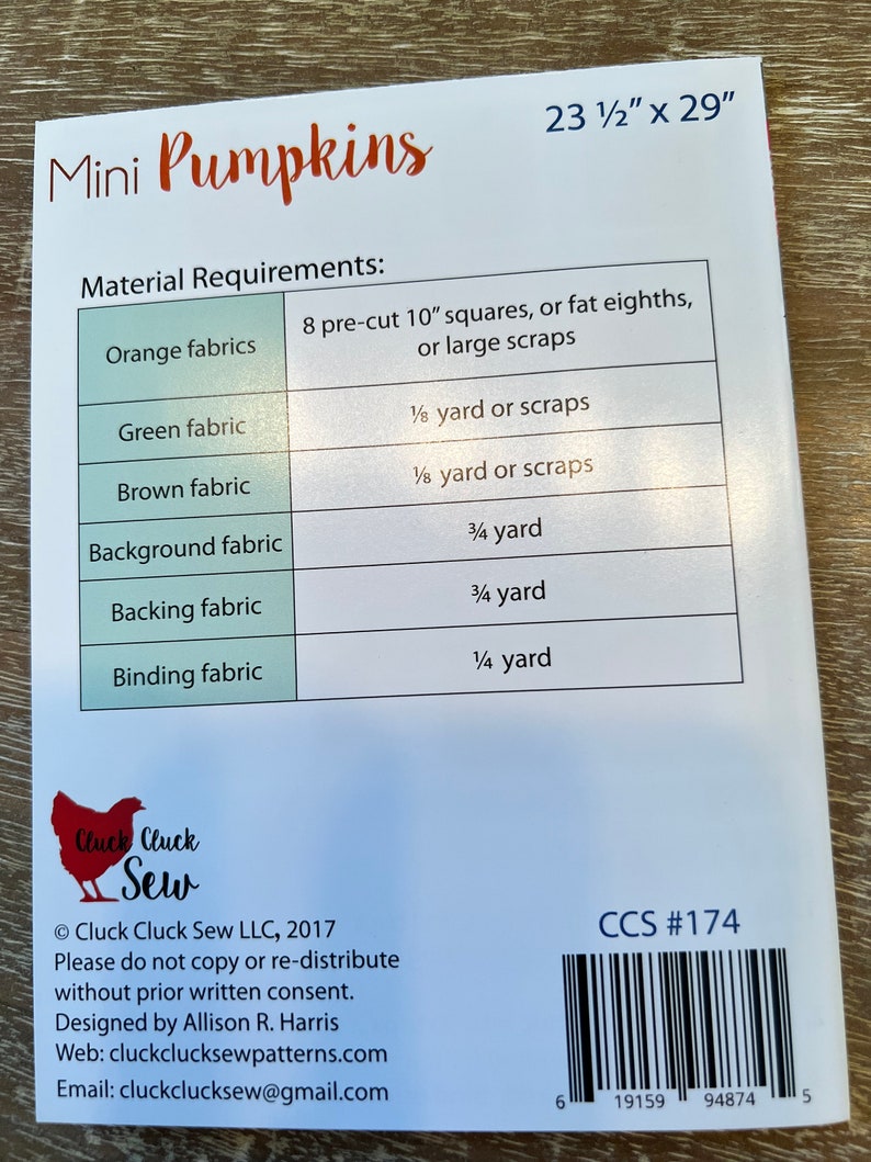 May include: Mini Pumpkins quilting pattern with material requirements listed in a table. The pattern is 23 1/2 inches by 29 inches. The pattern is from Cluck Cluck Sew LLC and includes the copyright year 2017.