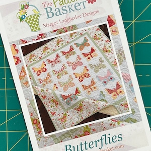 May include: A quilting pattern for a quilt featuring a butterfly design. The pattern is titled "Butterflies" and is from "The Pattern Basket" by Margot Languedoc Designs. The website address is www.thepatternbasket.com.
