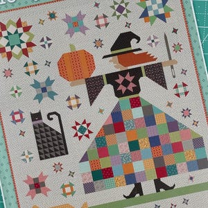 May include: A quilting pattern featuring a witch with a pumpkin, a black cat, and a variety of patchwork stars. The pattern is titled "The Quilted Witch" and includes the text "Bee in my Bonne"