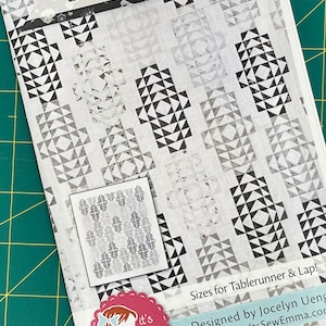 May include: A black and white quilt pattern with the title "Lantern Lights" and the text "Sizes for Tablerunner & Lap! Designed by Jocelyn Ueng www.ltsSewEmma.com".