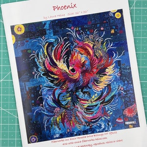 May include: A colorful mosaic pattern of a phoenix rising from the ashes. The pattern is made up of small squares of different colors, including red, orange, yellow, green, blue, and purple. The phoenix is depicted in a dynamic pose, with its wings spread wide and its head tilted back. The background is a dark blue, with hints of other colors. The image is titled "Phoenix" and is by Laura Heine. The image is 36 inches by 36 inches.