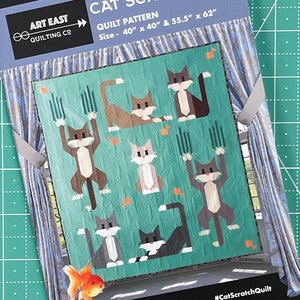 May include: A quilt pattern featuring a design of cats scratching a post. The quilt is made up of various shades of brown, gray, and white. The background is a teal blue with a wavy pattern. The quilt is 40 inches by 40 inches or 55.5 inches by 62 inches. The pattern is called "Cat Scratch" and is by Art East Quilting Co.