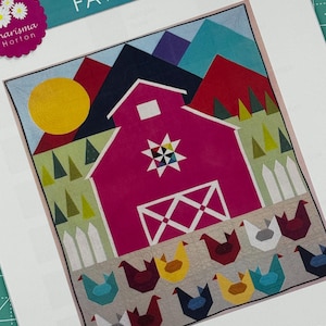 May include: A quilt pattern featuring a pink barn with a white star and a white X on the door. The barn is surrounded by green trees, red and blue mountains, and a yellow sun. There are also white picket fences and a row of colourful chickens at the bottom of the pattern. The pattern is titled "FAWN ACRES" and is 72" x 84".