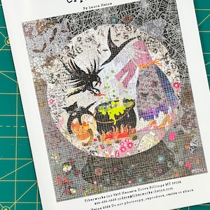 May include: A colorful, illustrated pattern for a quilt featuring a witch stirring a cauldron with a black cat and a raven. The pattern is titled "Crystal Ball" by Laura Heine. The pattern includes instructions for making the quilt and contact information for the designer.