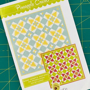 May include: A quilt pattern booklet titled "Pineapple Crush" by Fig Tree & Co. The booklet features two quilt designs, one with a blue and yellow colour scheme and the other with a green and red colour scheme. The text on the booklet says "Basic Simple Piecing, No Templates! No Rulers!"