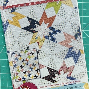 Puede incluir: Un patrón de acolchado llamado "Swallowtail" con un diseño de patchwork colorido. El patrón incluye instrucciones para hacer un camino de mesa, una manta, una colcha para el regazo y una colcha de tamaño doble. Está diseñado por Jocelyn Ueng y presenta el texto "it's sew emma®" y "www.ltsSewEmma.com".