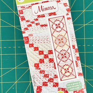 May include: A quilting pattern for a table runner called "Mimosa" by Fig Tree & Co. The pattern features a red and white design with a floral motif. The pattern number is FTQ#1625.