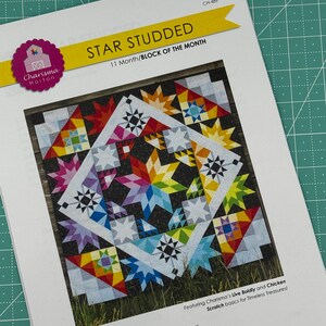 May include: A quilting pattern for a quilt block called "Star Studded". The pattern is for a 96 inch by 96 inch quilt. The pattern features a colorful quilt block with a variety of stars and geometric shapes.