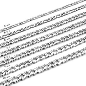 May include: A set of silver chain necklaces in various widths, ranging from 4mm to 10mm. The chains are laid out in a staggered pattern, with the widest chain at the bottom and the narrowest chain at the top.