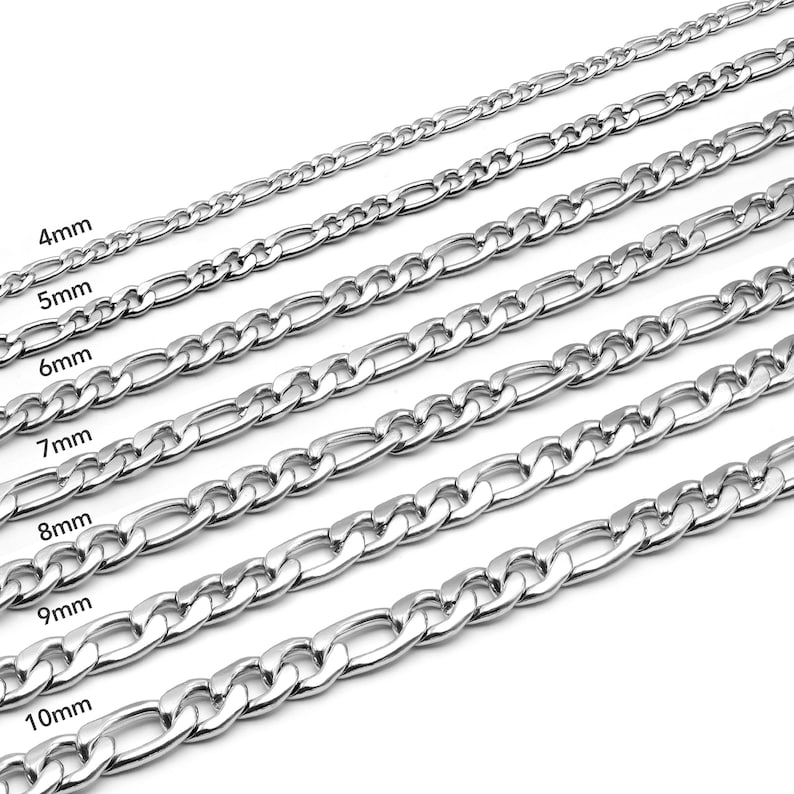May include: A set of silver chain necklaces in various widths, ranging from 4mm to 10mm. The chains are laid out in a staggered pattern, with the widest chain at the bottom and the narrowest chain at the top.