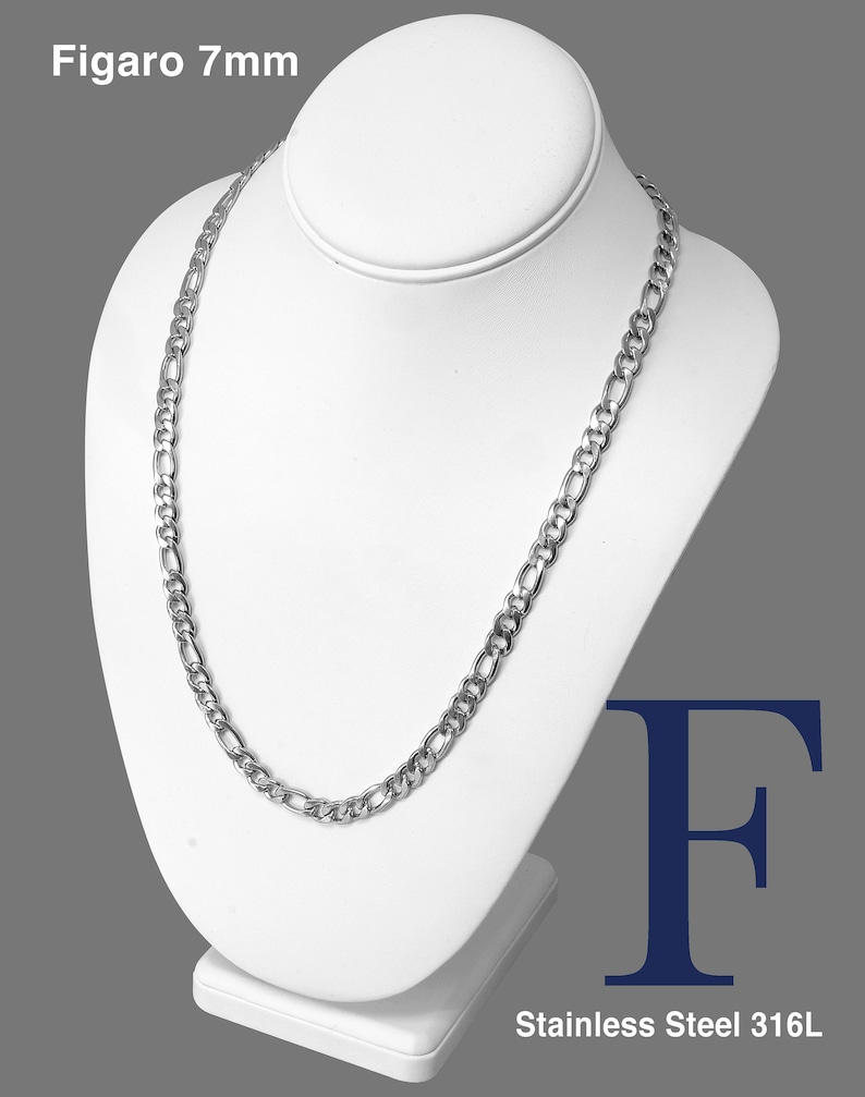 May include: A silver Figaro chain necklace, 7mm wide, made from stainless steel 316L. The chain is displayed on a white mannequin bust.