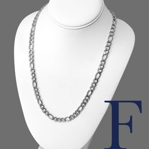 May include: A silver Figaro chain necklace, 8mm wide, displayed on a white mannequin. The necklace is made of stainless steel 316L.