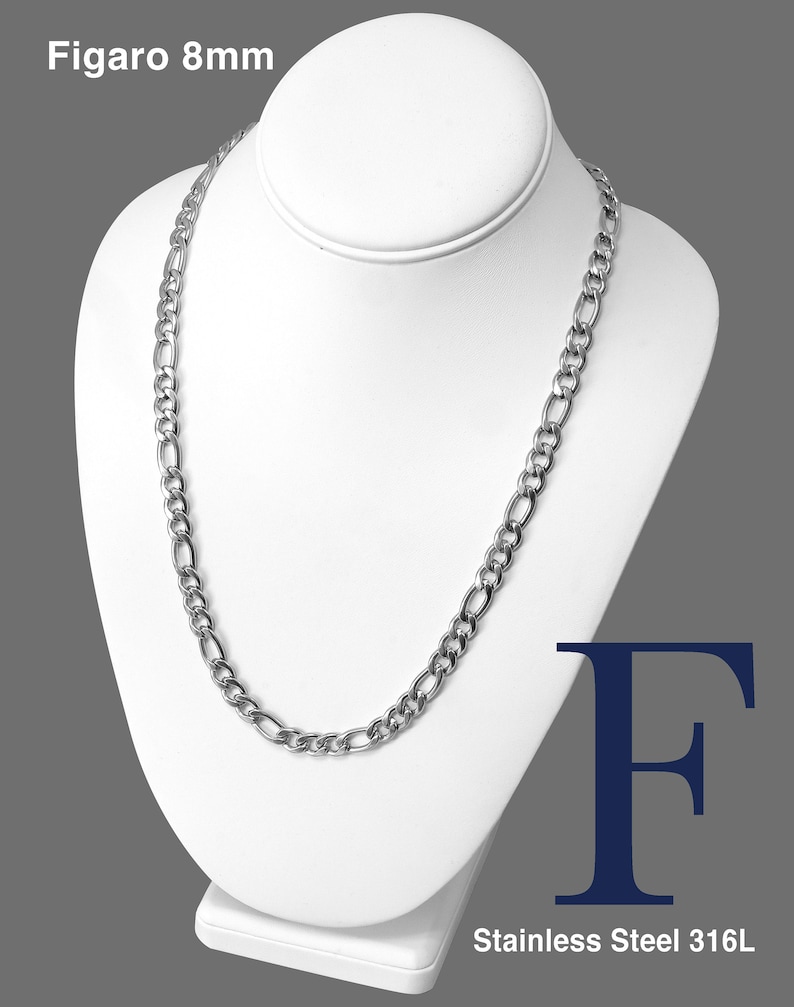 May include: A silver Figaro chain necklace, 8mm wide, displayed on a white mannequin. The necklace is made of stainless steel 316L.