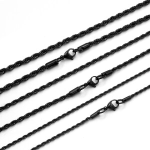 May include: Five black rope chains of varying lengths with lobster claw clasps.