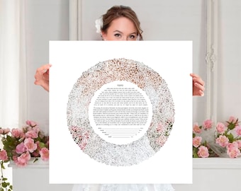 May include: A white paper Ketubah with a floral design. The Ketubah is held by a person. The floral design is a circular pattern of roses. The text is in Hebrew and English. The Ketubah is a marriage contract.