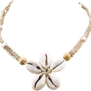 May include: A beige macrame necklace with white shell beads and a white shell flower pendant.