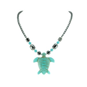 May include: A turquoise sea turtle pendant necklace with a silver chain and black beads.