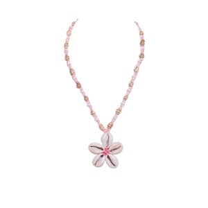 May include: A pink and white shell necklace with a flower pendant made of white shells and a pink center.
