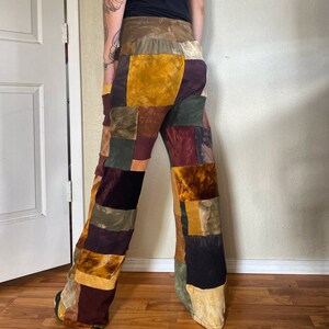 May include: Patchwork pants with a mix of brown, green, yellow, and red fabrics. The pants have a wide leg and a relaxed fit.