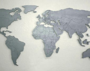 Magnetic wooden world map XL with engraved country borders, floating on the wall