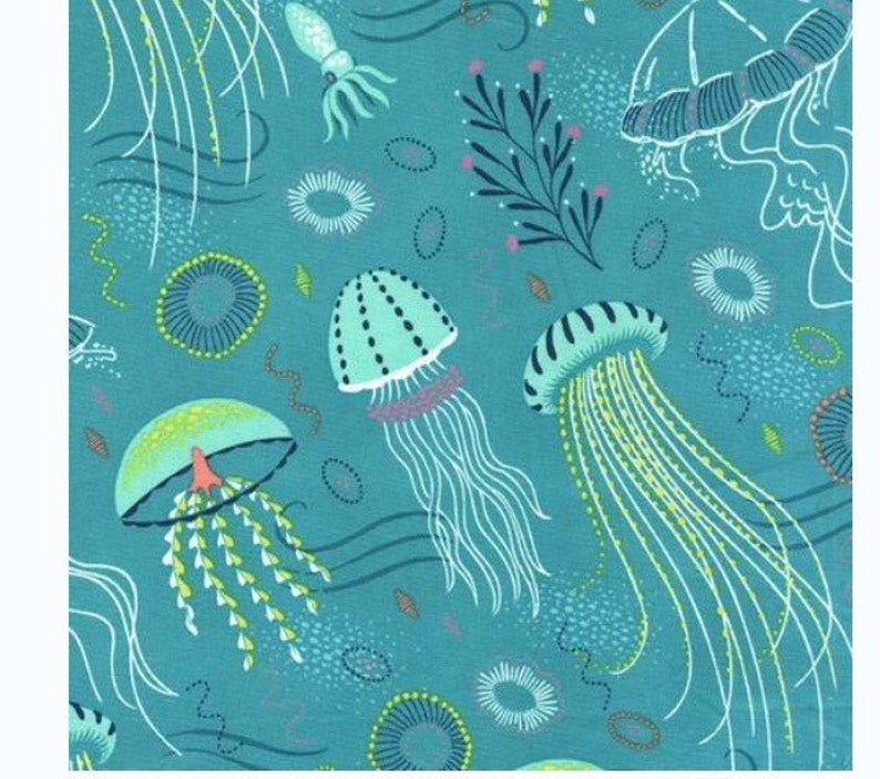May include: A teal blue fabric with a repeating pattern of jellyfish, seaweed, and other sea life. The jellyfish are in various shades of blue and green, with long, flowing tentacles.