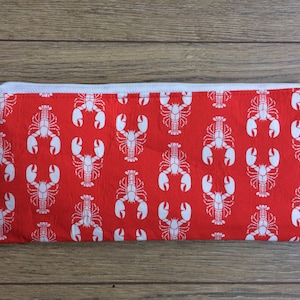 May include: Red zippered pouch with a white lobster pattern.