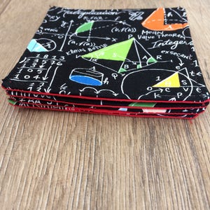 May include: A stack of four black coasters with a red border. The coasters feature a white design of mathematical equations, geometric shapes, and the words "Klein Bottle", "Mean Value Theorem", and "Integer".