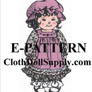 Puede incluir: Un patrón imprimible para una muñeca de tela que lleva un vestido y un sombrero rosas. La muñeca tiene el pelo negro y una expresión dulce. El patrón está disponible para descargar en ClothDollSupply.com.