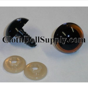 May include: Two brown plastic safety eyes with black pupils and a shiny finish. The eyes are 12mm in diameter and come with two plastic washers. The eyes are attached to a black plastic screw.