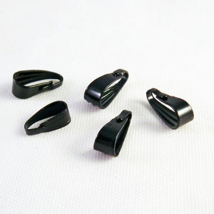 May include: Five black metal pendant clasps, also known as crimp beads, for jewellery making.